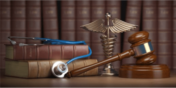 Gavel, stethoscope and caduceus sign on books background. Medicine laws and legal,
